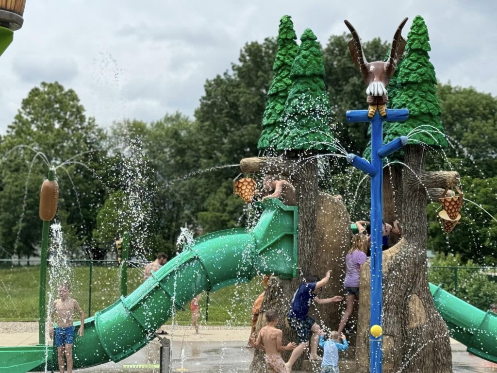 children playing on splash pad slide